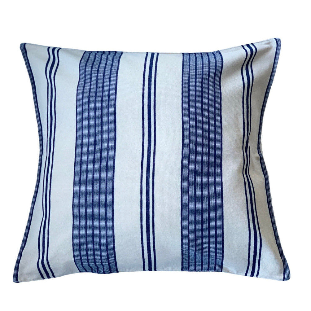 Striped blue and white pillow on a white background